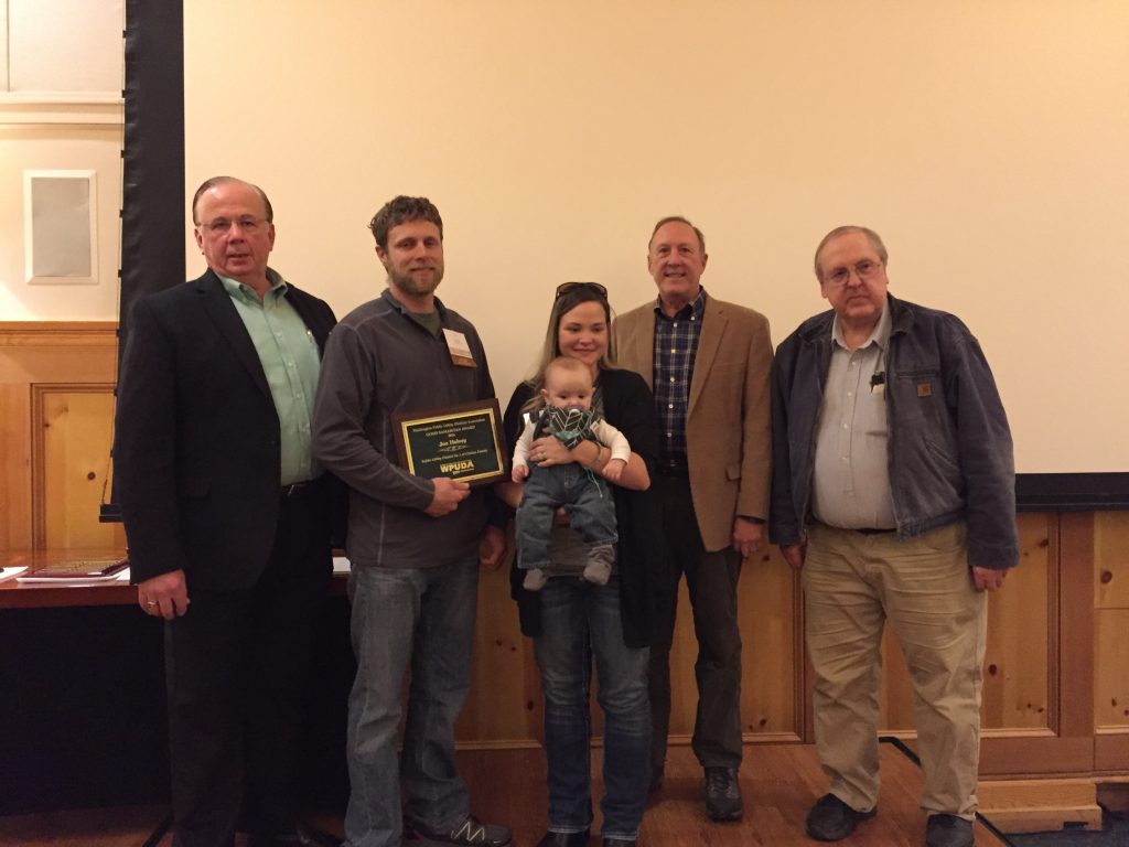 From left to right, Clallam County PUD General Manager Doug Nass joins WPUDA 2016 Good Samaritan Recipient Joe Helvey, Allison Helvey and their 5 month old son, Utility Services Manager Fred Mitchell, and Commissioner Hugh Haffner at the WPUDA awards banquet on 12/01/16.